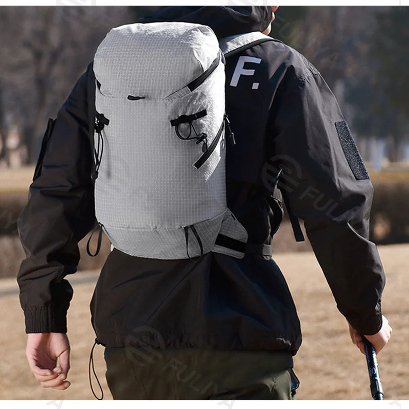 Guangzhou Fuliya Industry Co.,Ltd C-81473 Lightweight water-repellent hiking pack with hydration, pole attachment, whistle, reflective strips, and pockets - for hiking, cycling, travel.