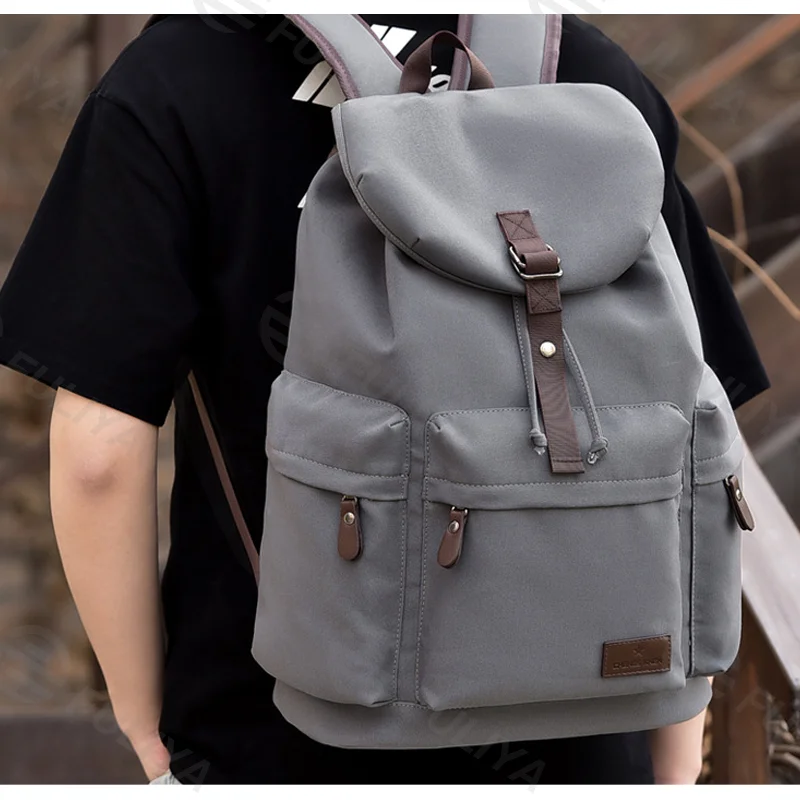 Guangzhou Fuliya Industry Co.,Ltd C-81106 Canvas backpack, waterproof fabric, large capacity with compartments, drawstring closure, magnetic buckle, front/back/side pockets, and comfortable handle - luggage strap for commuting, business, and school.