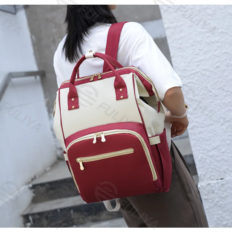 Guangzhou Fuliya Industry Co.,Ltd C-81126 Multi-functional mommy backpack, water-resistant, large capacity, wet/dry separation, foil-insulated bottle pocket, USB port, side tissue pocket, and adjustable straps - for baby outings and travel.