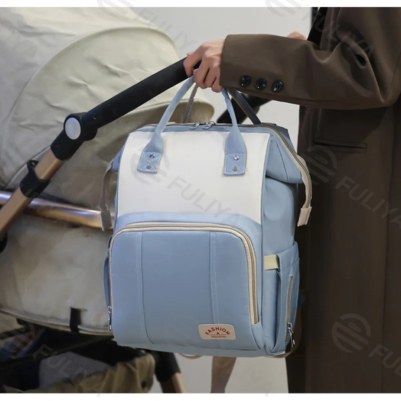 Guangzhou Fuliya Industry Co.,Ltd C-81129 Mommy backpack, water-resistant, large capacity, foil-insulated bottle compartment, wet/dry pocket, back zipper pocket, stretch side pocket, lockable handles, and luggage strap - for baby outings and travel.