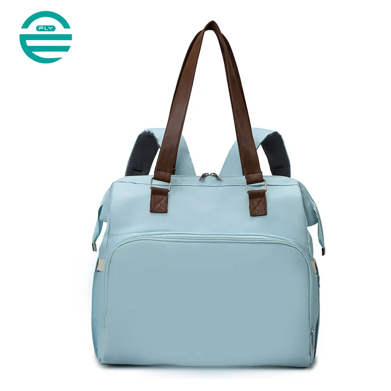 Guangzhou Fuliya Industry Co.,Ltd C-81133 Multi-functional mommy bag, water-resistant, large capacity, foil-insulated bag, wet/dry pocket, and hidden straps - hand or backpack carry with luggage strap for baby outings and travel.