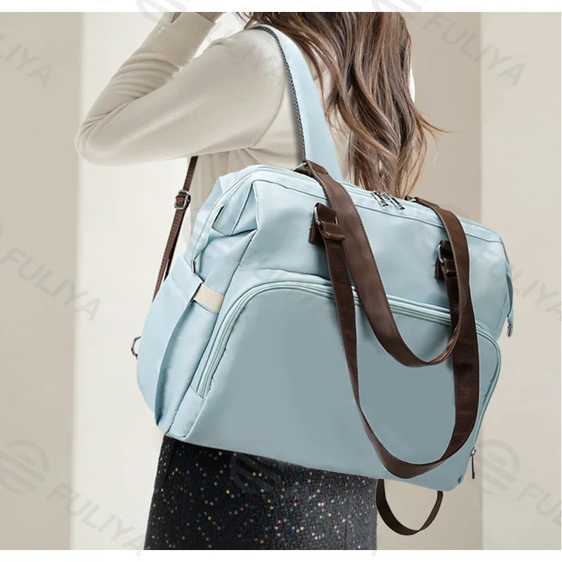 Guangzhou Fuliya Industry Co.,Ltd C-81133 Multi-functional mommy bag, water-resistant, large capacity, foil-insulated bag, wet/dry pocket, and hidden straps - hand or backpack carry with luggage strap for baby outings and travel.