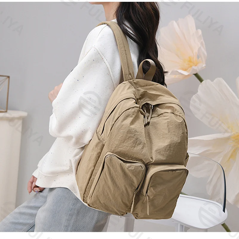 Guangzhou Fuliya Industry Co.,Ltd C-81237 Lightweight waterproof nylon backpack, large capacity with multi-layer storage, dual front zipper pockets, side pockets, inner zipper pocket, and adjustable straps - for commuting, travel, and school.