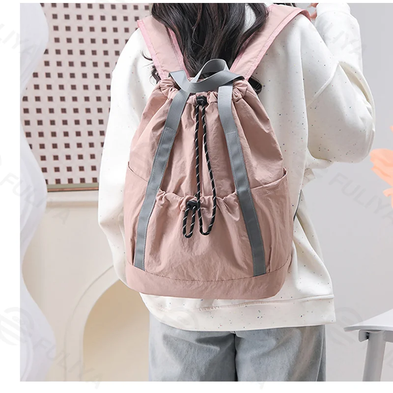 Guangzhou Fuliya Industry Co.,Ltd C-81238 Lightweight waterproof nylon drawstring backpack, large main compartment, magnetic front pocket, back zipper pocket, side pocket, adjustable straps, and comfortable handle - for cycling, gym, college, and sports.