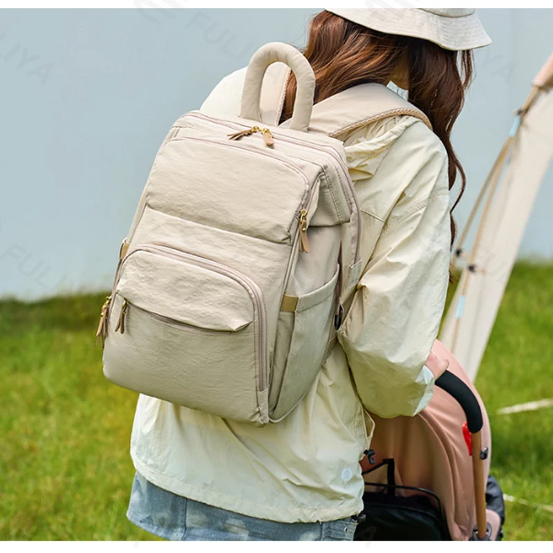 Guangzhou Fuliya Industry Co.,Ltd C-81299 Mommy backpack, water-resistant, large capacity, insulated bottle compartment, wide-opening main pocket, side tissue pocket, and comfortable handle - for baby outings.