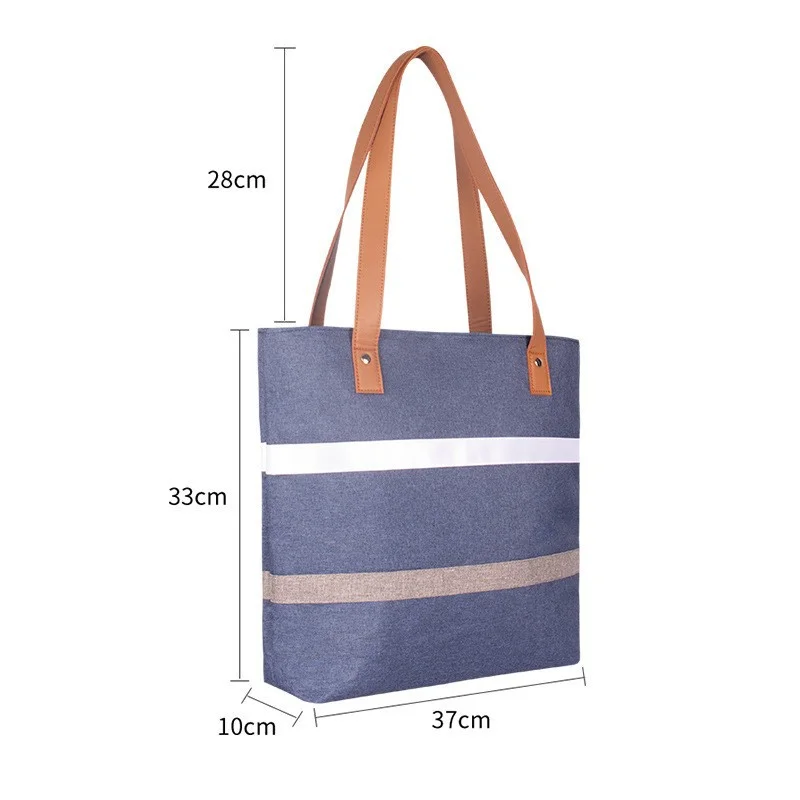 Guangzhou Fuliya Industry Co.,Ltd C-81396 Reusable striped thermal lunch tote. Compact exterior with spacious interior for lunch boxes, fruit, water bottles, and snacks. Reinforced handle for easy carry to office or picnic.