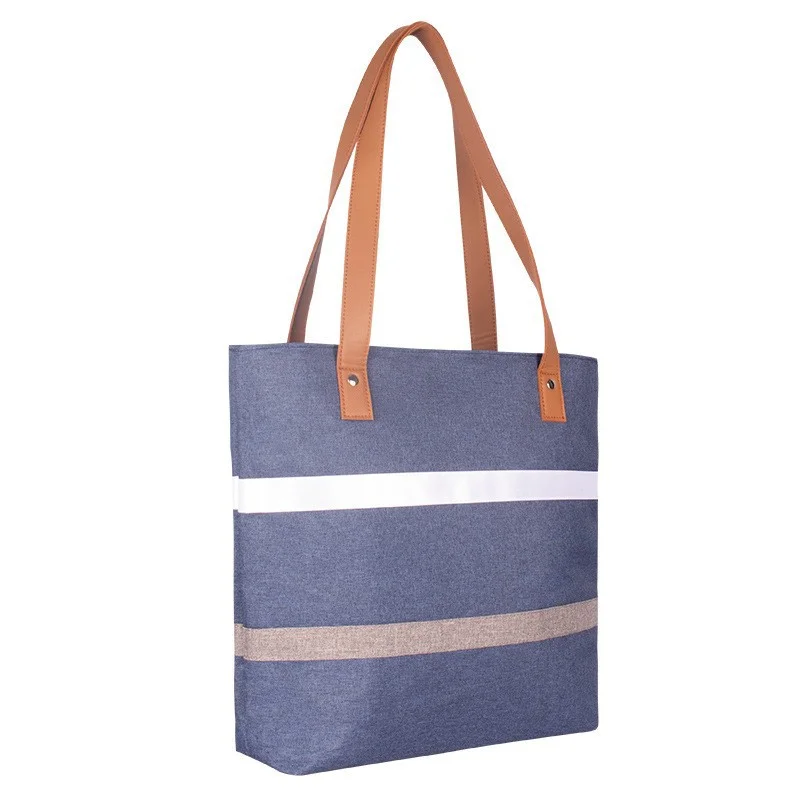 Guangzhou Fuliya Industry Co.,Ltd C-81396 Reusable striped thermal lunch tote. Compact exterior with spacious interior for lunch boxes, fruit, water bottles, and snacks. Reinforced handle for easy carry to office or picnic.