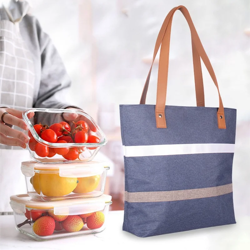 Guangzhou Fuliya Industry Co.,Ltd C-81396 Reusable striped thermal lunch tote. Compact exterior with spacious interior for lunch boxes, fruit, water bottles, and snacks. Reinforced handle for easy carry to office or picnic.
