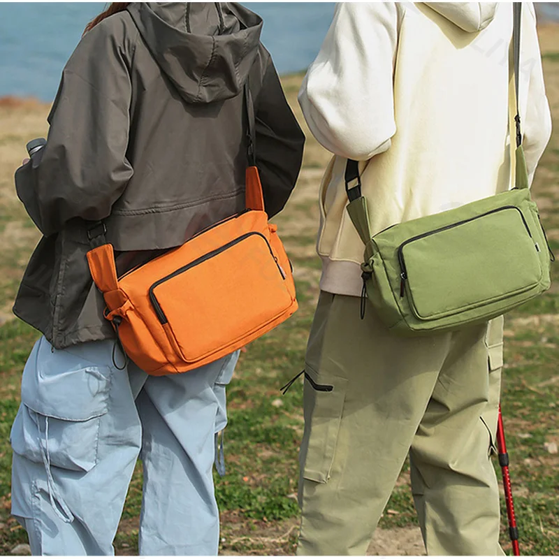Guangzhou Fuliya Industry Co.,Ltd C-81435 This water-repellent shoulder bag has multi-layer pockets, an adjustable strap, and durable fabric - for commuting and outdoor use.