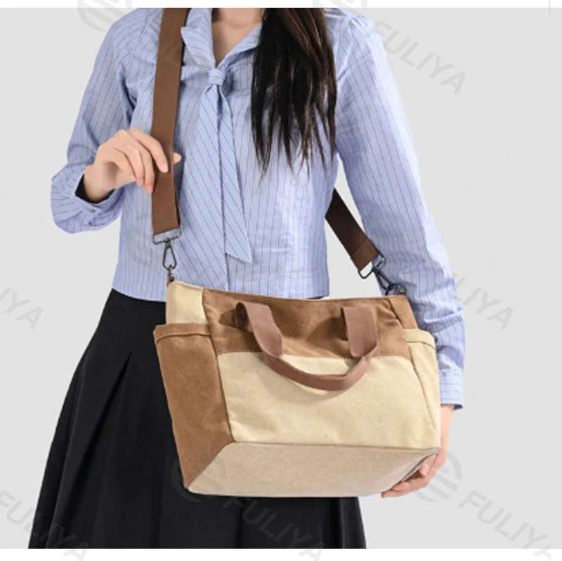 Guangzhou Fuliya Industry Co.,Ltd C-81447 This spliced canvas bag is lightweight and versatile, with hand/shoulder/crossbody carry, multi-layer pockets, adjustable strap, and side pocket - for commuting and campus.