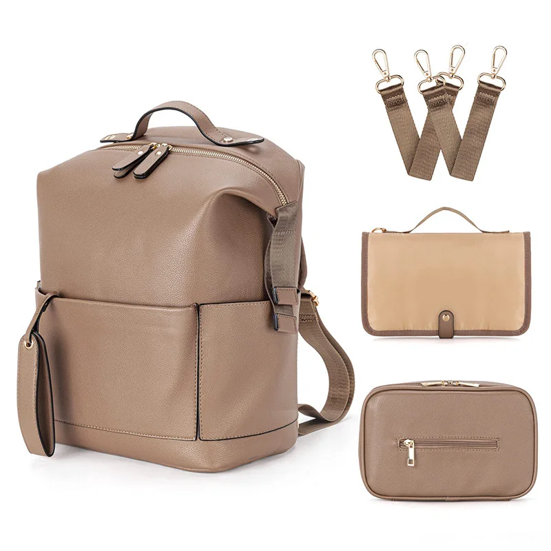 Guangzhou Fuliya Industry Co.,Ltd C-81465 This PU mommy bag offers large capacity with multiple compartments, is waterproof and easy to clean, attaches to strollers, and has comfortable shoulder straps - ideal for outings and travel with baby.