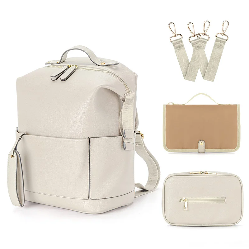 Guangzhou Fuliya Industry Co.,Ltd C-81465 This PU mommy bag offers large capacity with multiple compartments, is waterproof and easy to clean, attaches to strollers, and has comfortable shoulder straps - ideal for outings and travel with baby.