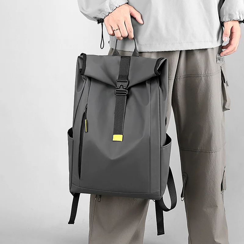 Guangzhou Fuliya Industry Co.,Ltd C-80944 Men's roll-top backpack with multi-layer large capacity . Features breathable shoulder straps and a trolley sleeve for easy carry. For business trips, short travel, and commuting.