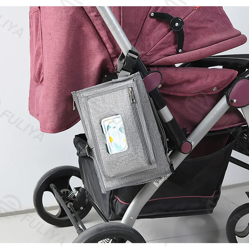 Guangzhou Fuliya Industry Co.,Ltd C-81029 Portable baby changing pad bag, multi-functional foldable design, changing mat, storage pockets, tissue dispenser, zipper pocket, and handle - attaches to stroller or car for easy travel.